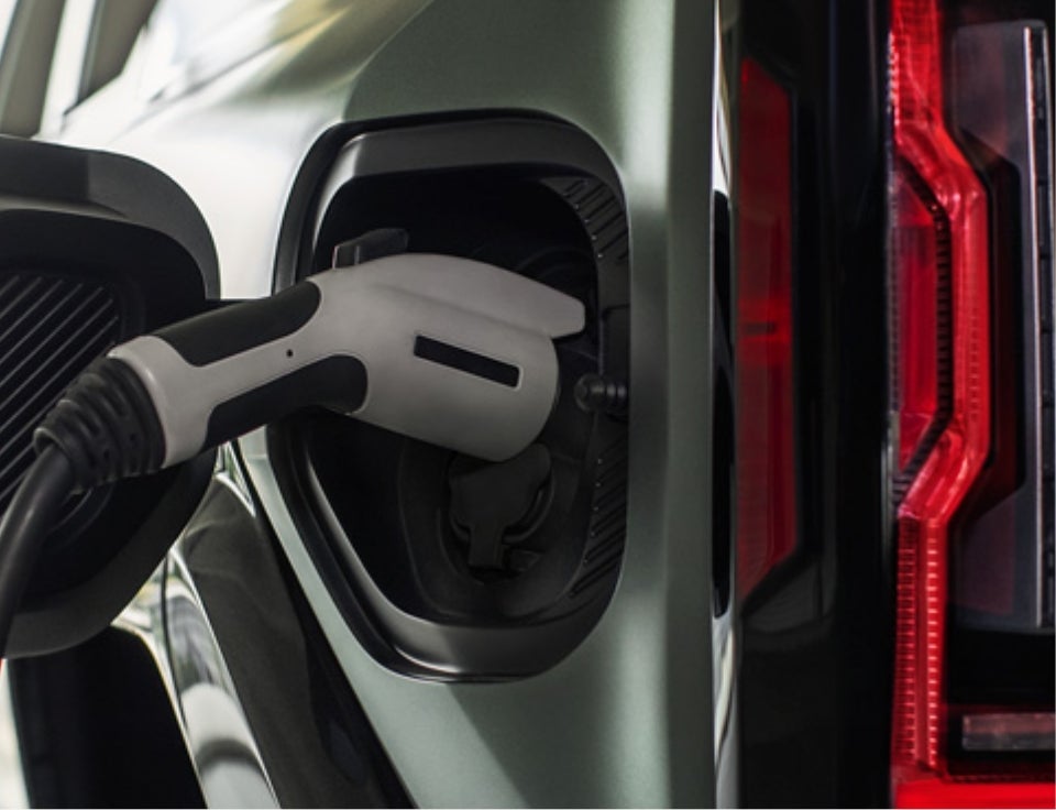 Close up of charging port with charger plugged in on a GMC Hummer EV SUV - Northpoint GMC in Newport VT
